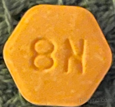 orange hexagon suboxone pill with m on it