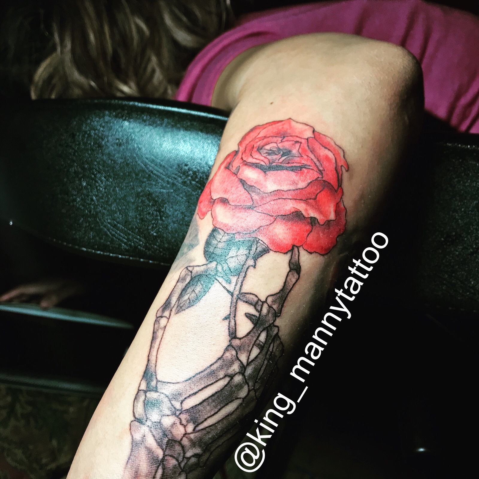 realistic skeleton hand holding rose tattoo