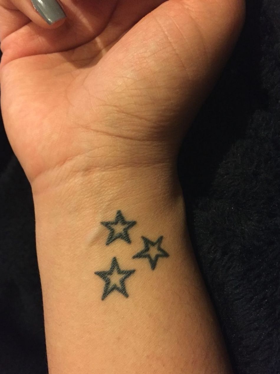 star tattoo on side wrist