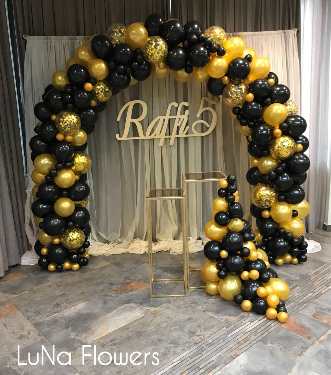 black and gold balloon arch