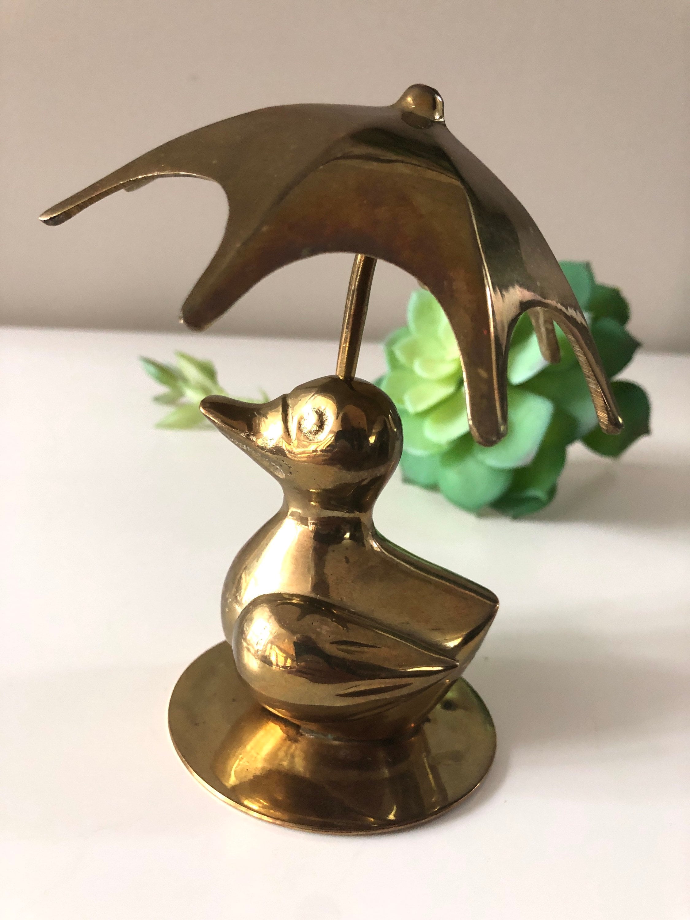 brass duck with umbrella