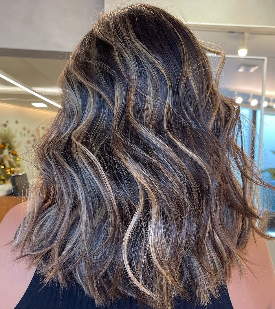 streaked blonde highlights on dark brown hair